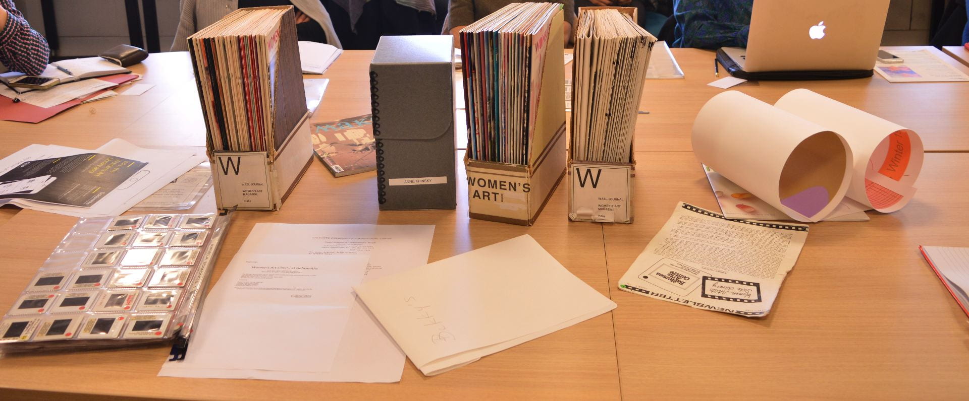 Archival material, slide files and art magazines on a table