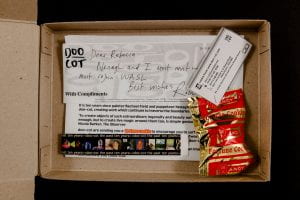 box with papers and a wrapped fortune cookie