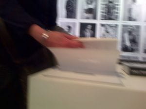 Catherine is looking through a book at an exhibition