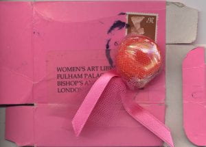 wrapped sweet on top of flattened small pink box stamped and addressed to the Women's Art Library at Fulham Palace