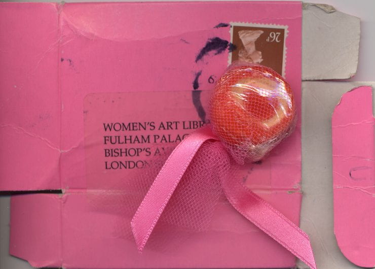 wrapped sweet on top of flattened small pink box stamped and addressed to the Women's Art Library at Fulham Palace