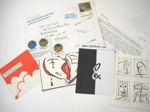 one of the Mail Art envelopes unpacked to show letter with 4 graphic works