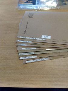 display of 7 document folders showing the titles