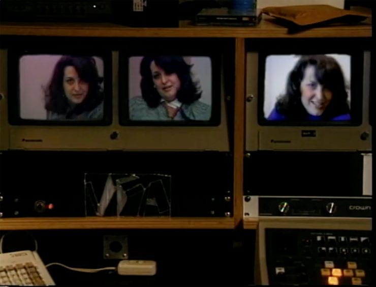 three metallic television monitors each showing a picture of the same woman in slightly different poses/
