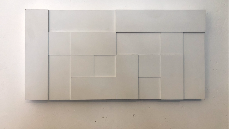 White geometric shapes on a rectangular canvas