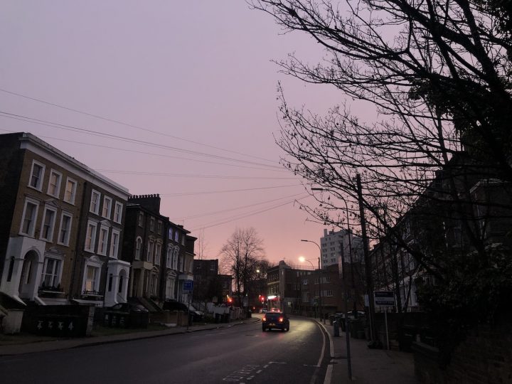 Pink and purple sunset over a residential street
