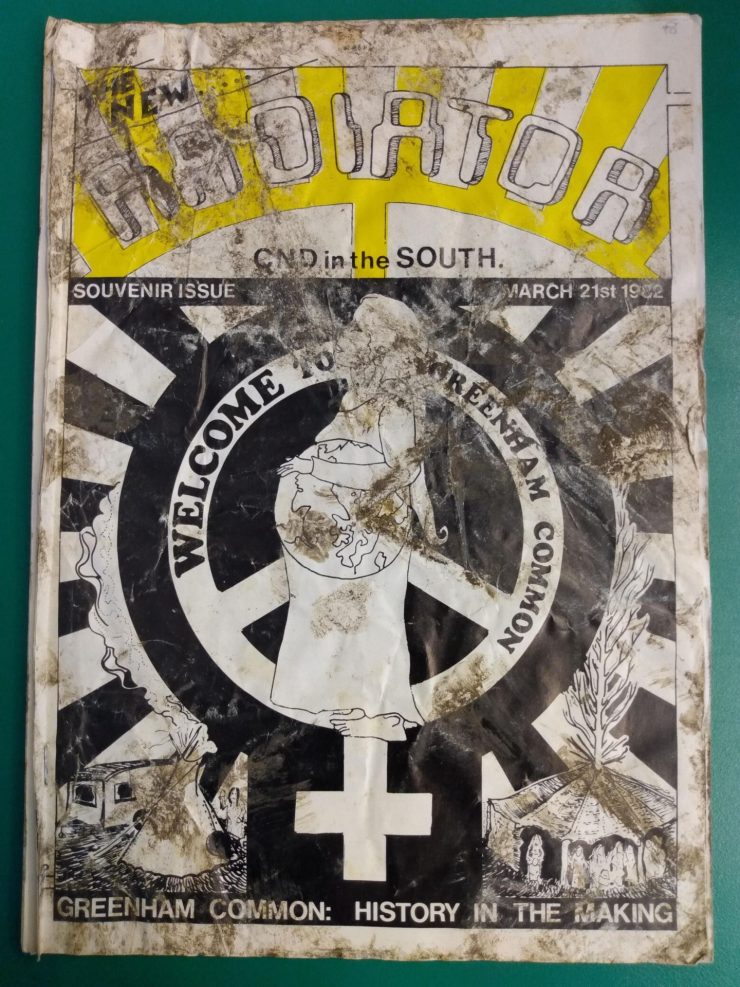 A muddy cover of a magazine titled Radiator, with the text "Welcome to Greenham Common" across the front