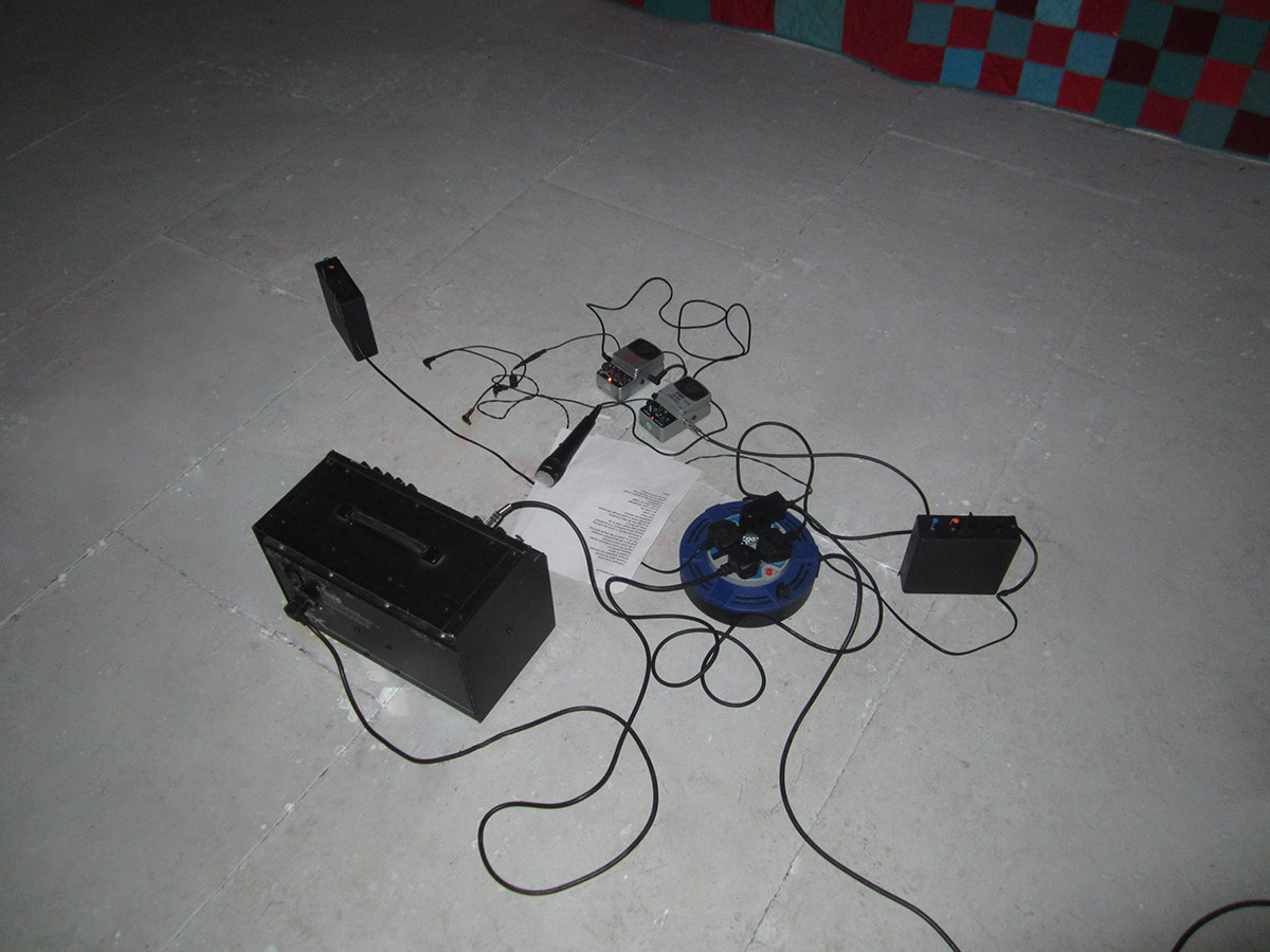 Photo of audio equipment on a grey floor.
