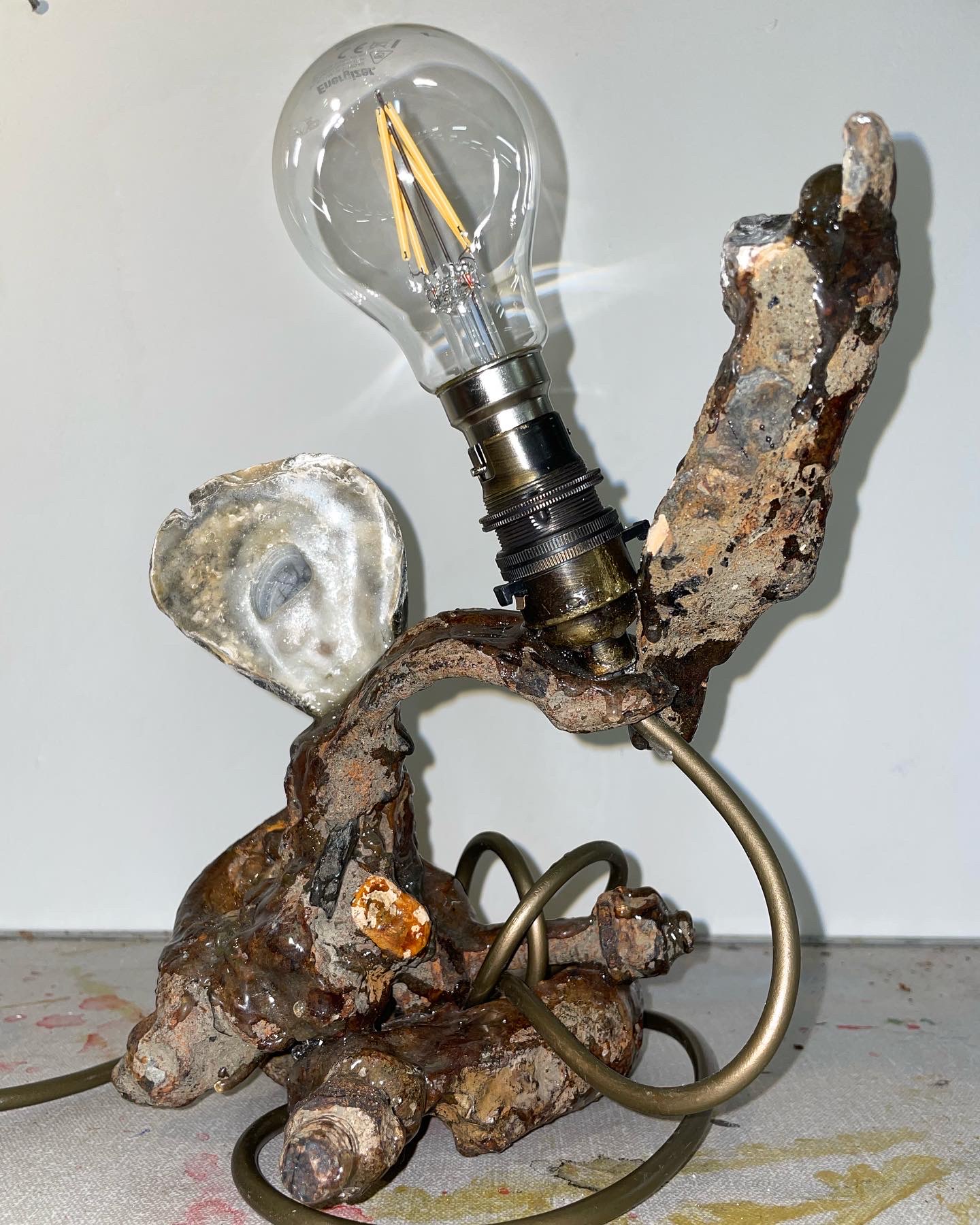 An assemblage light made out of various objects.