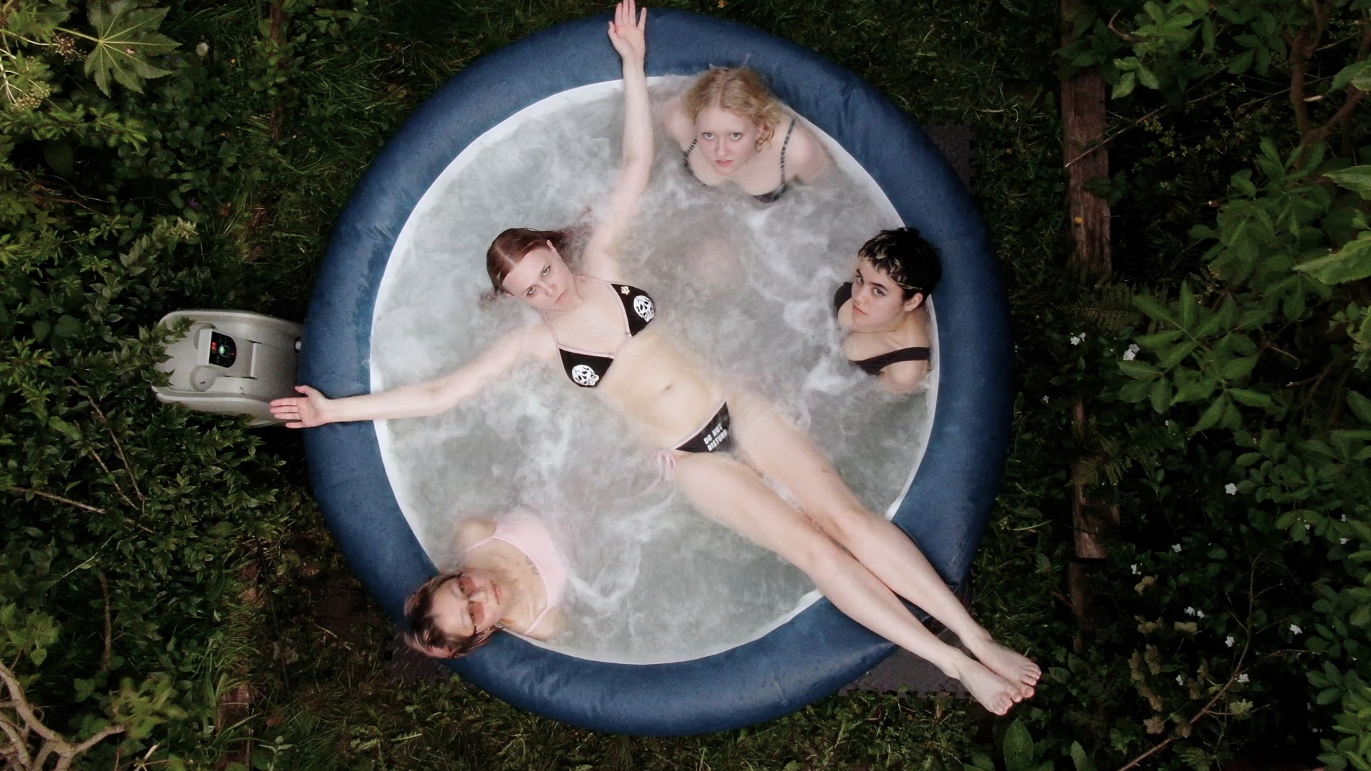 A bird's eye view of 4 people in a hot tub.