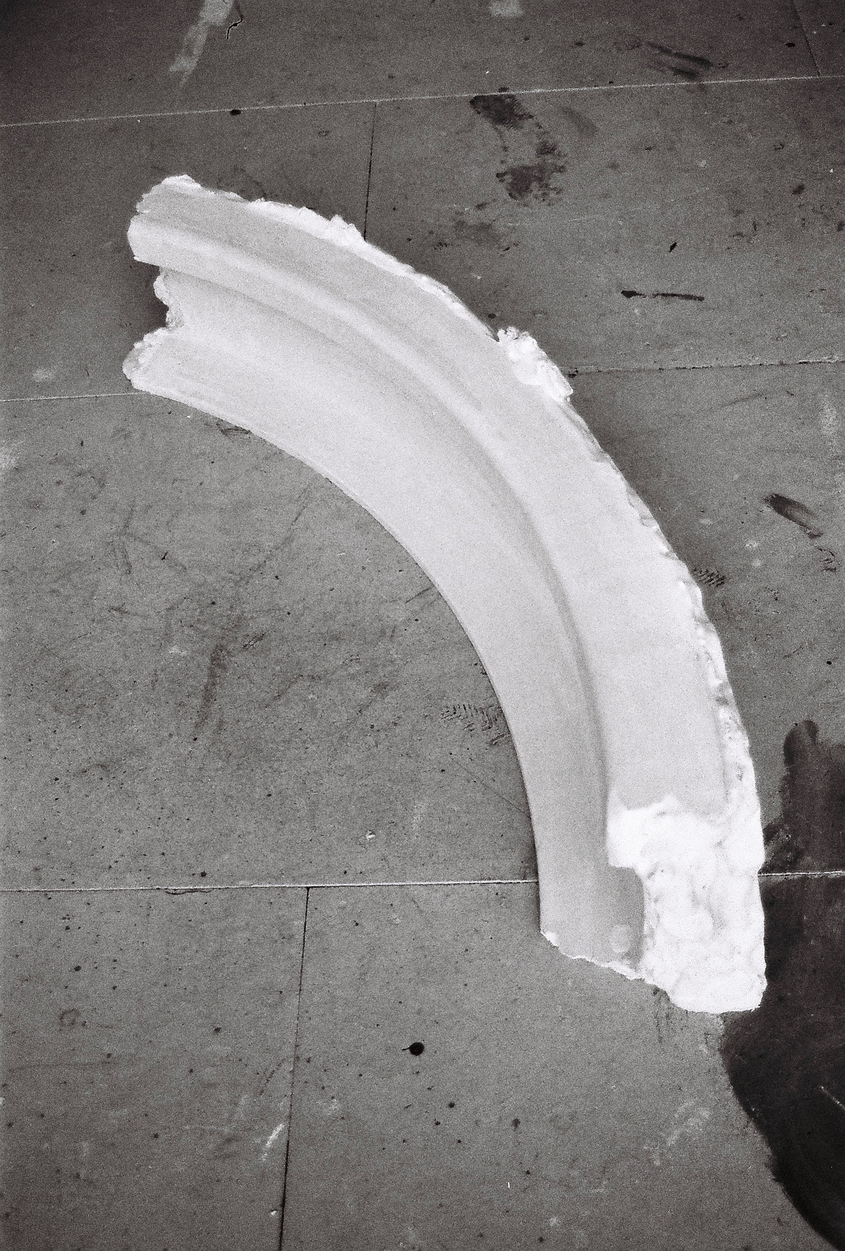 A curved, white plaster object.