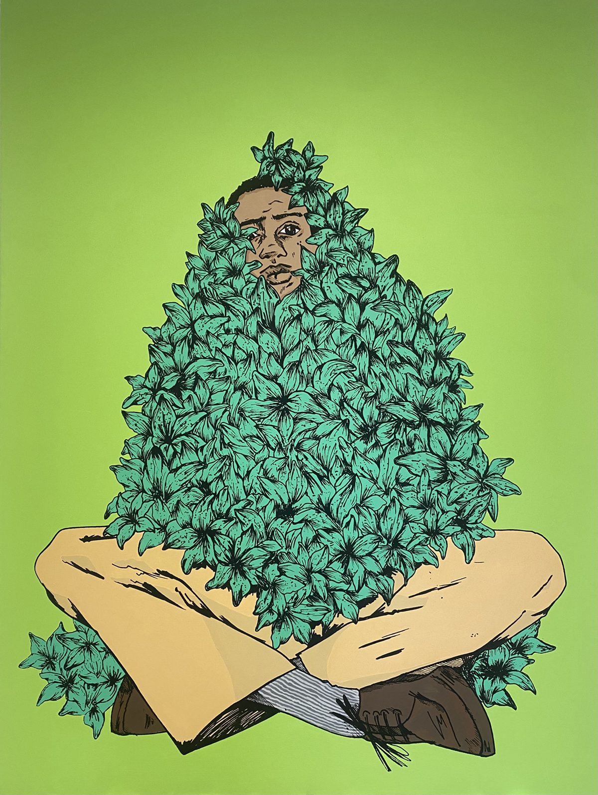 A man sits cross-legged against a green background, with a bush over his body.