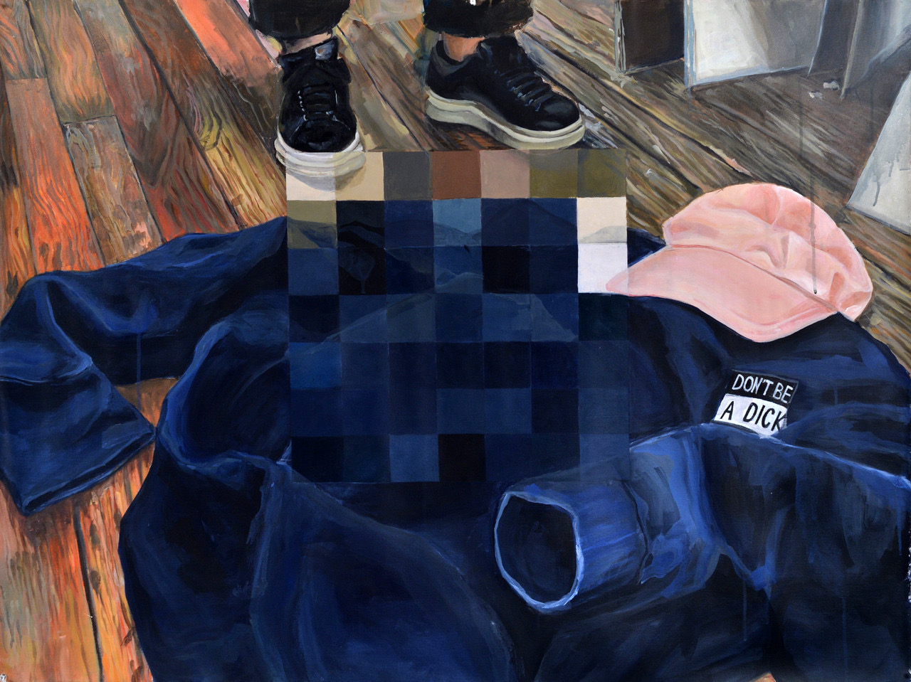A painting of a blue shirt on a wooden floor, with a black and white badge on the breast which says 'Don't be a Dick'.