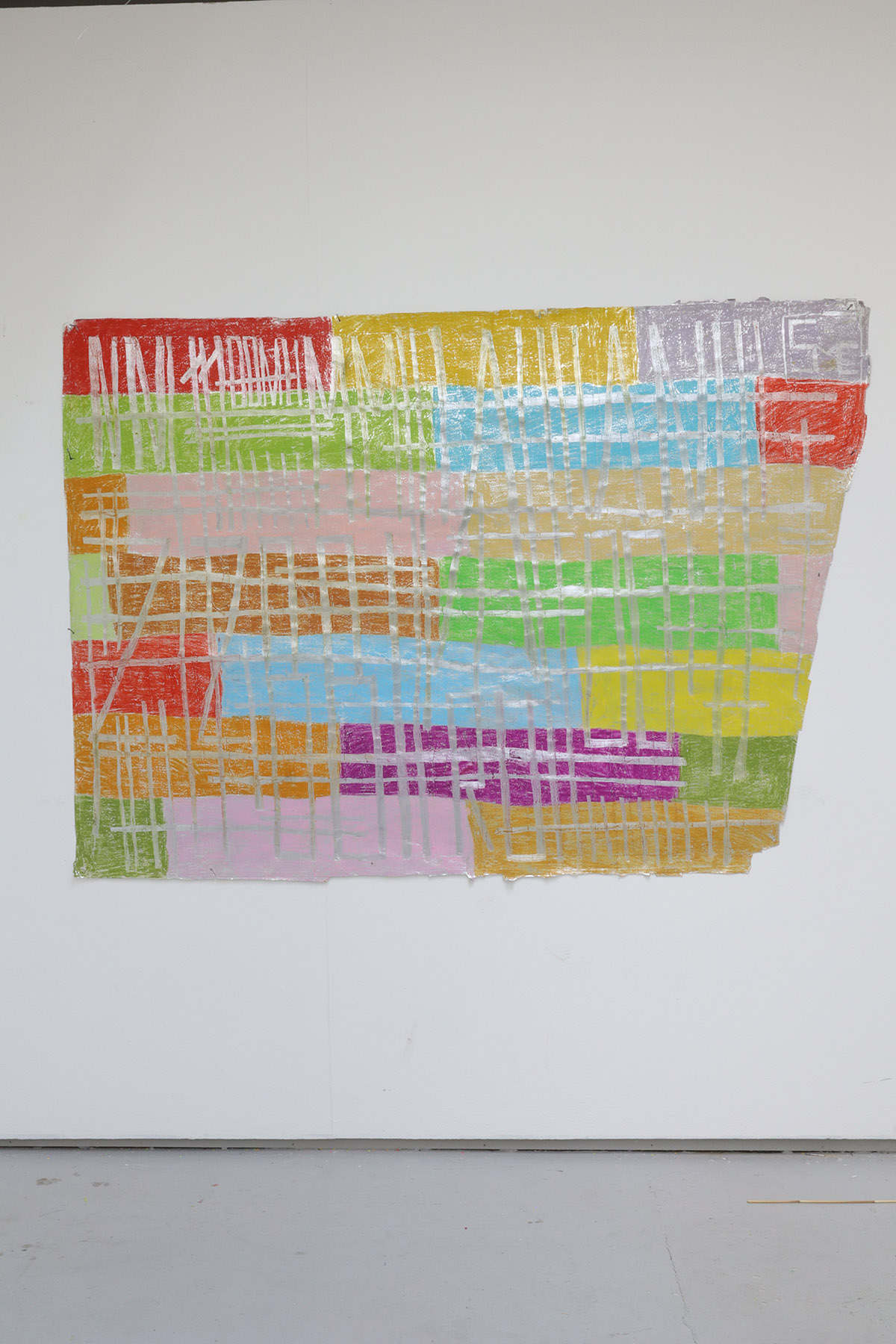 A colourful oil pastel drawing of rectangular blocks of colour, with a silver tape running through it, hanging on a white wall.