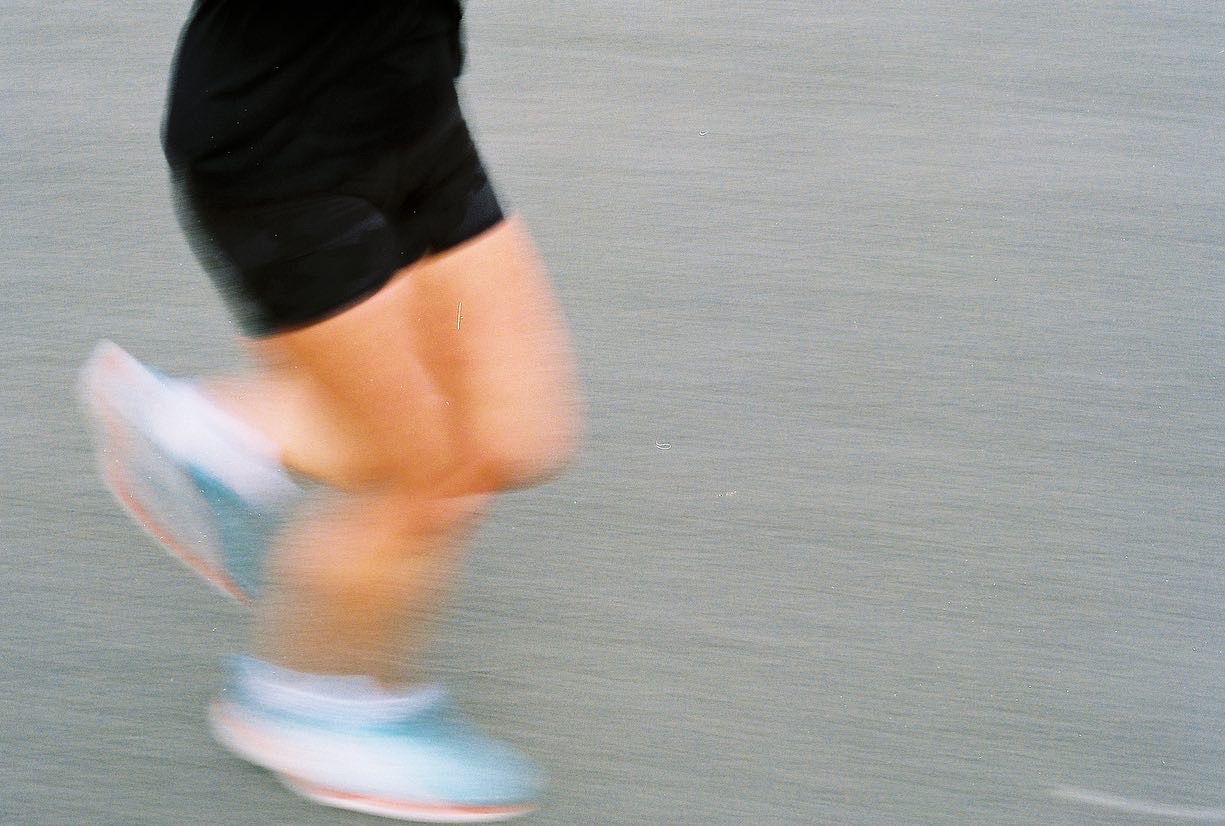 A blurry photo of some one running taken on 35mm film.
