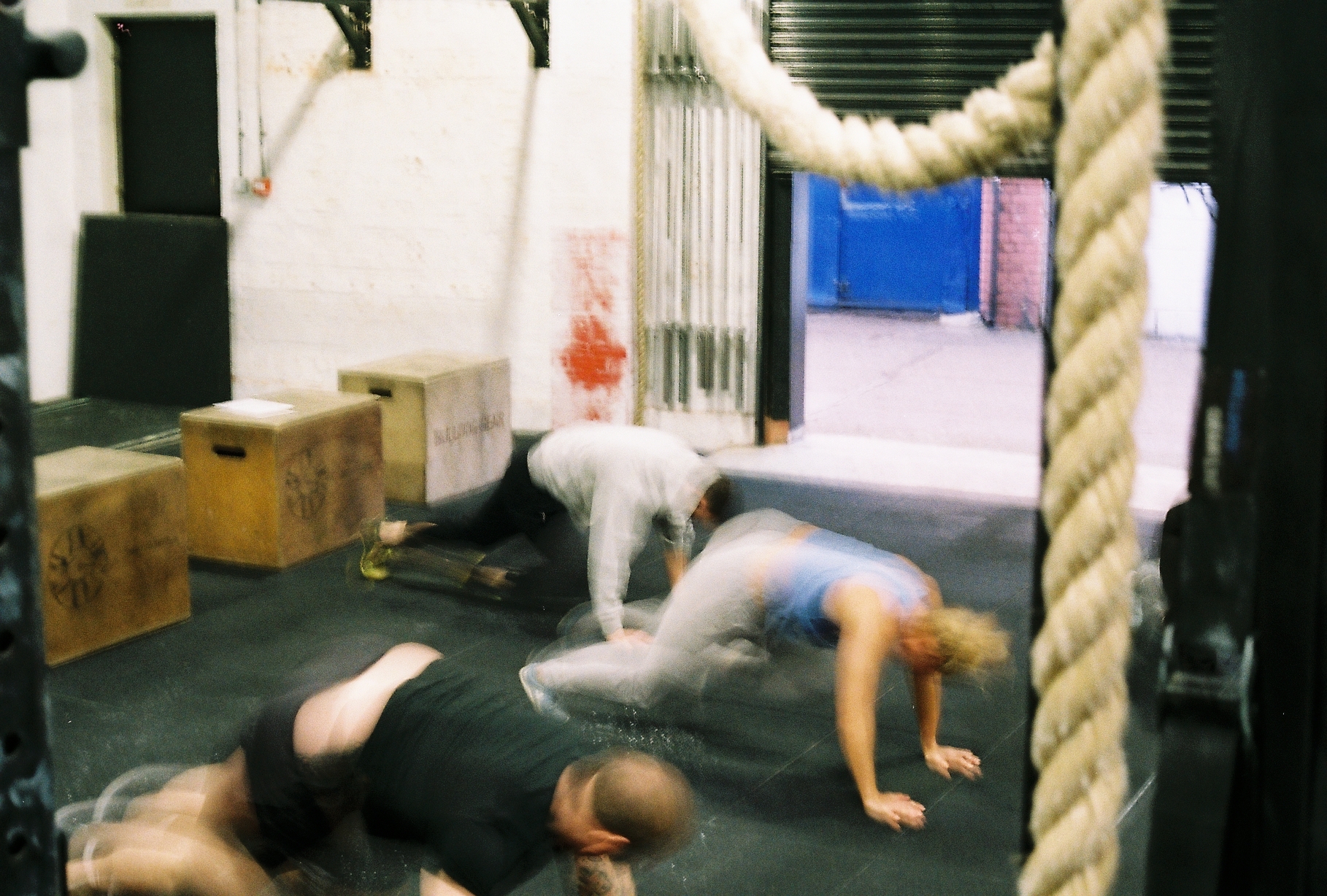 A photo of three people working out, taken on 35mm film 