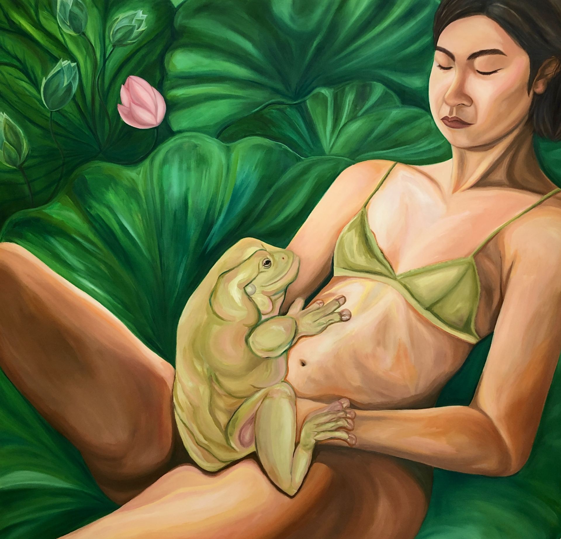 A girl sits on a background of lotus, holding a frog.