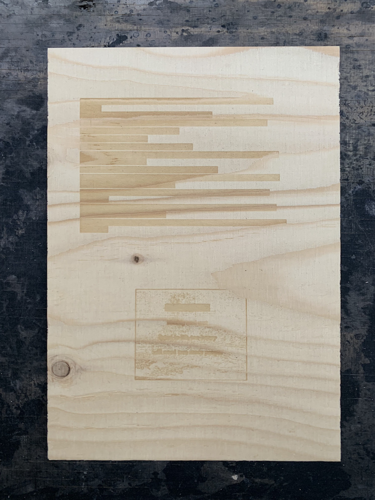 A page of text laser-etched on plywood.