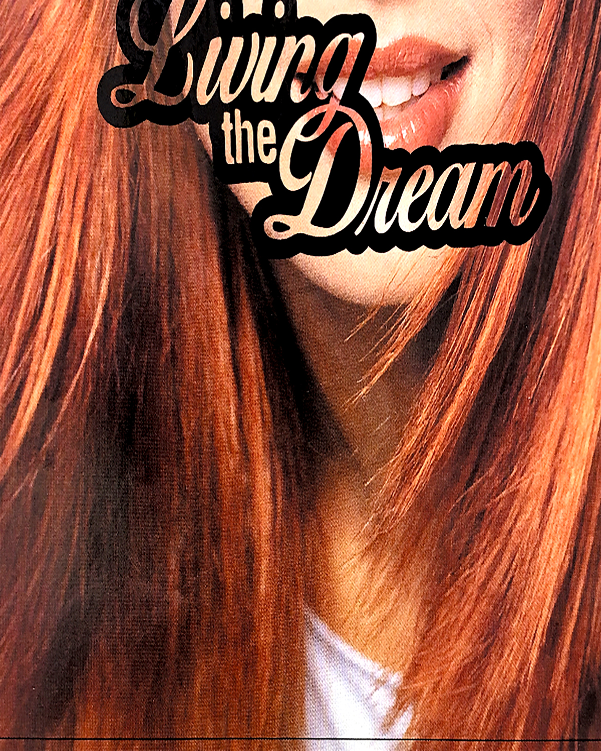 A close-up photo of a woman, with the phrase 'living the dream' written over her chin in black.