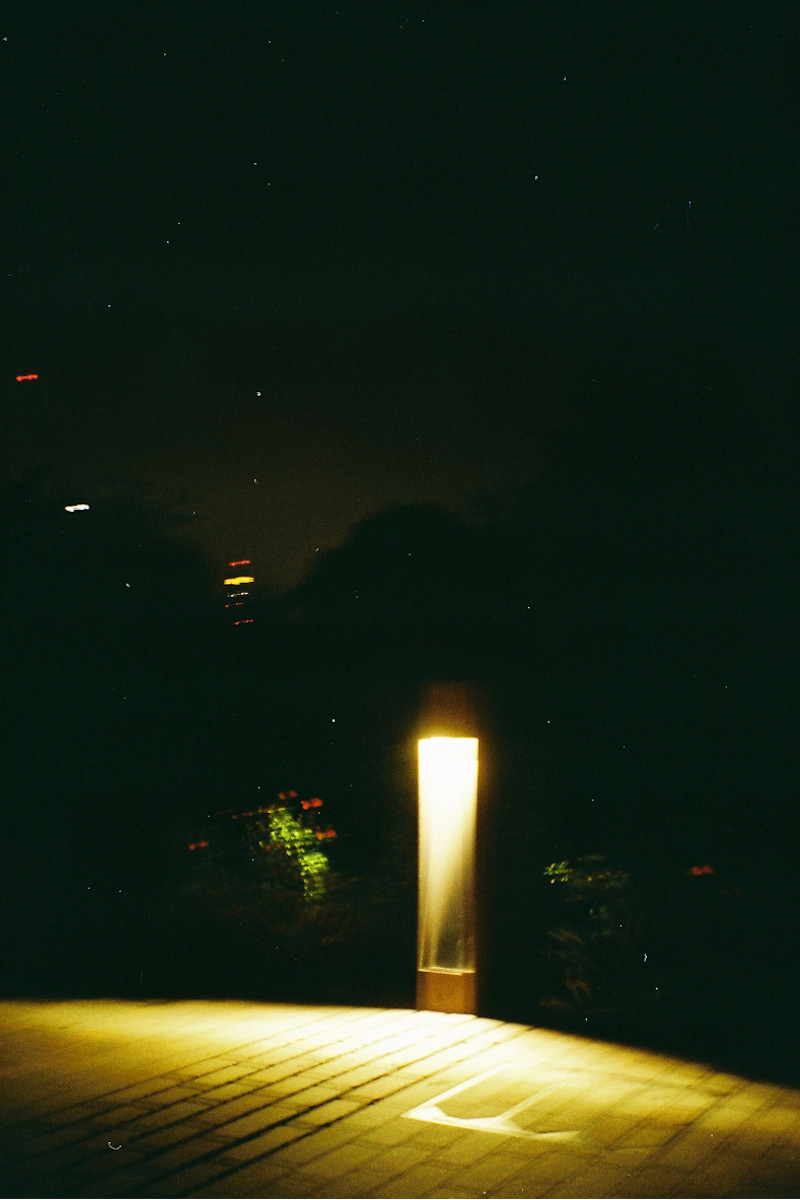 A photograph of a dark street.