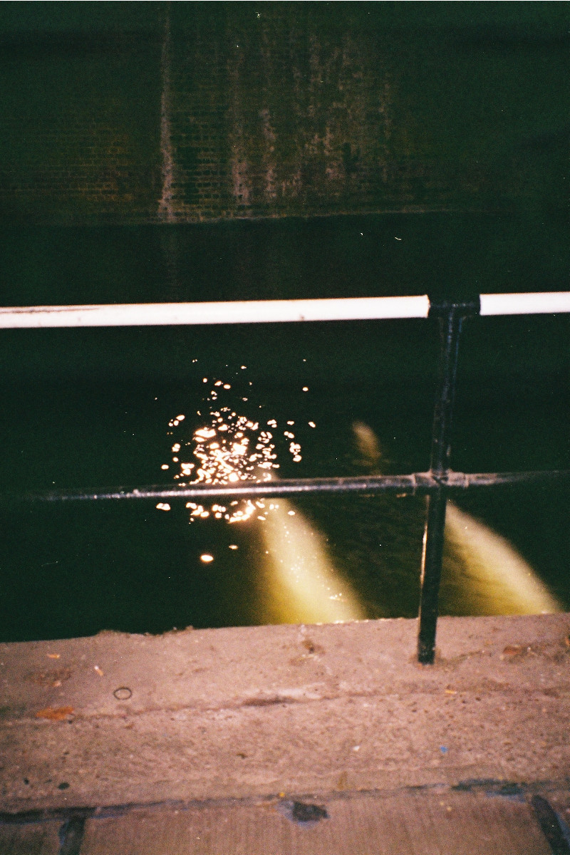 A photograph of a dimly lit body of water.