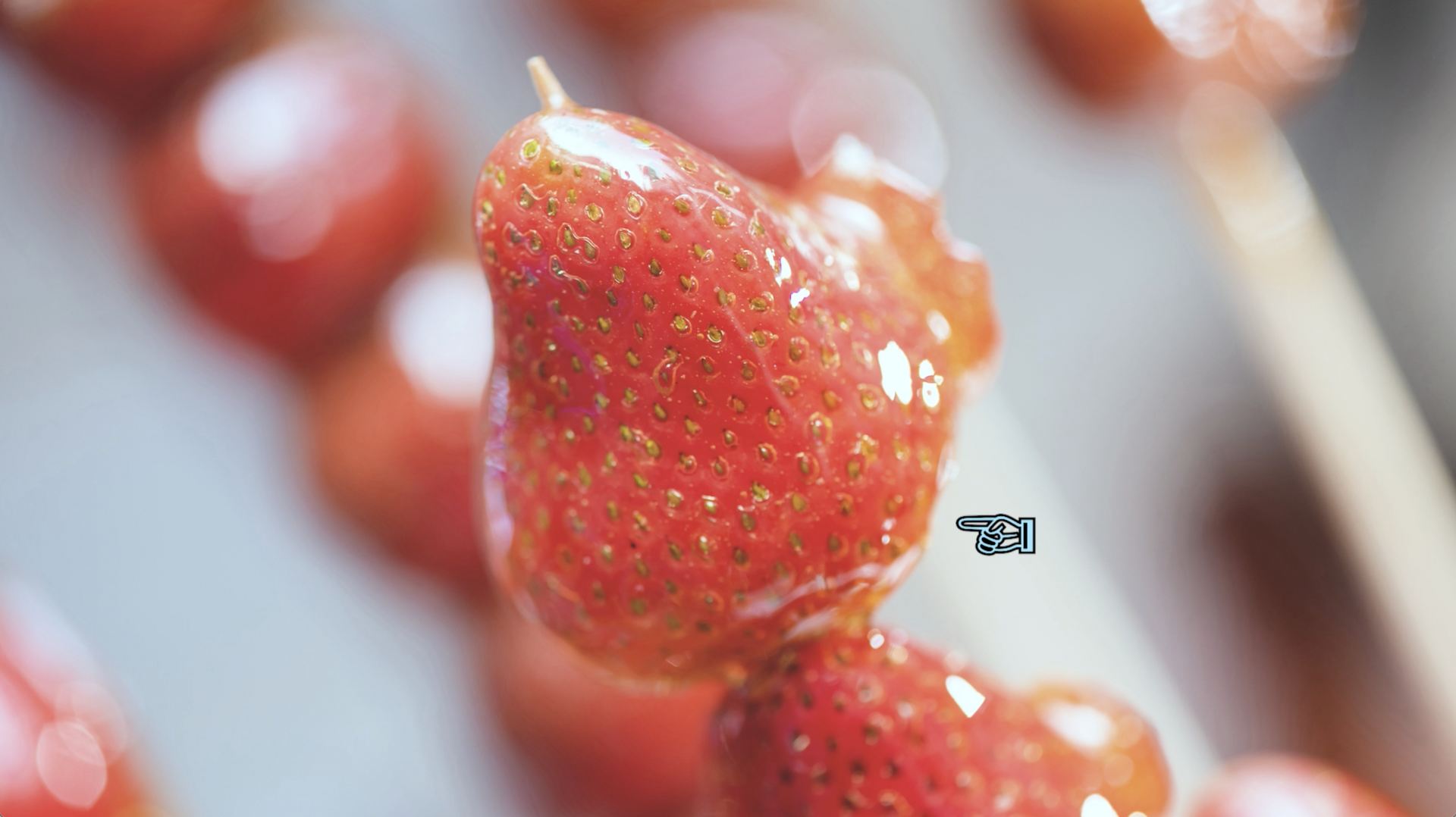 A close-up photo of a strawberry on a skewer.