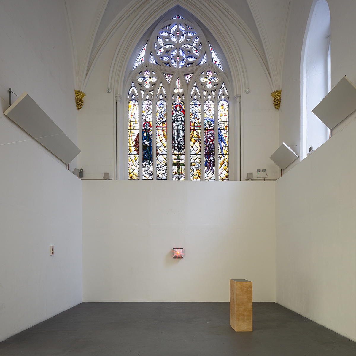 Installation view of sculptures made from Thermoformed PET, laser pointer, UV print on acrylic and glue, situated in a Church, beneath a stained-glass window.