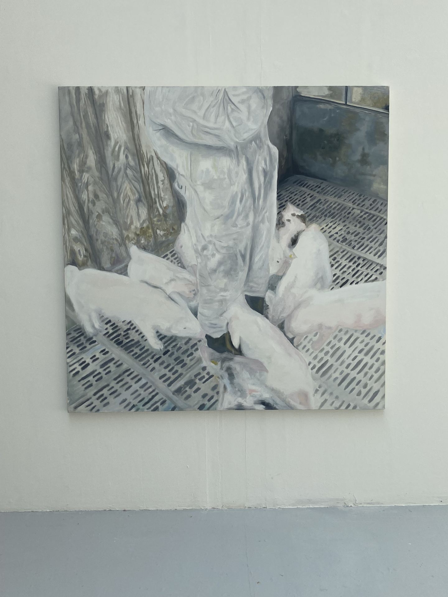 A painting of several pigs feeding on a metal floor..