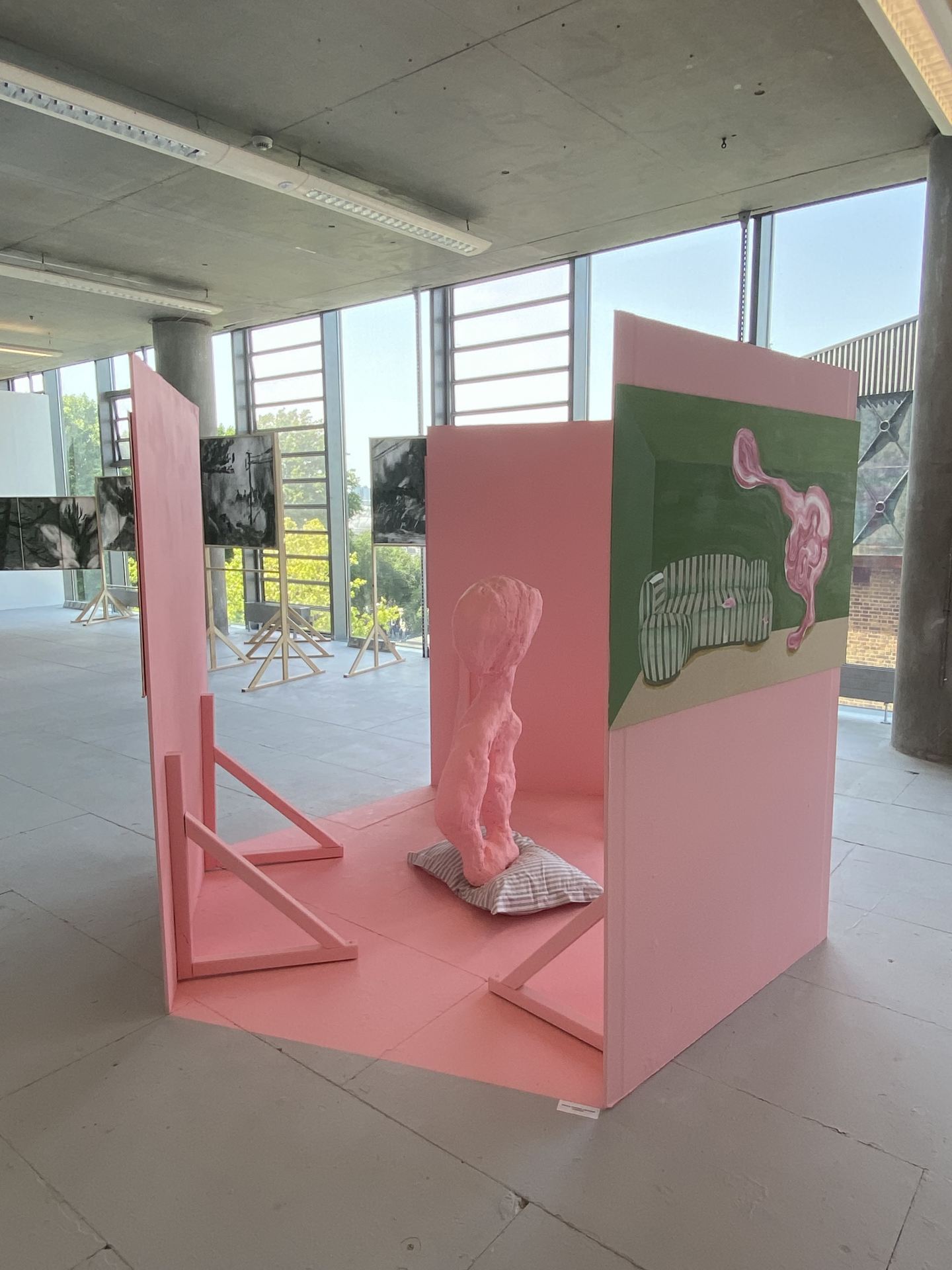A pink sculpture stood between three upright pink boards.