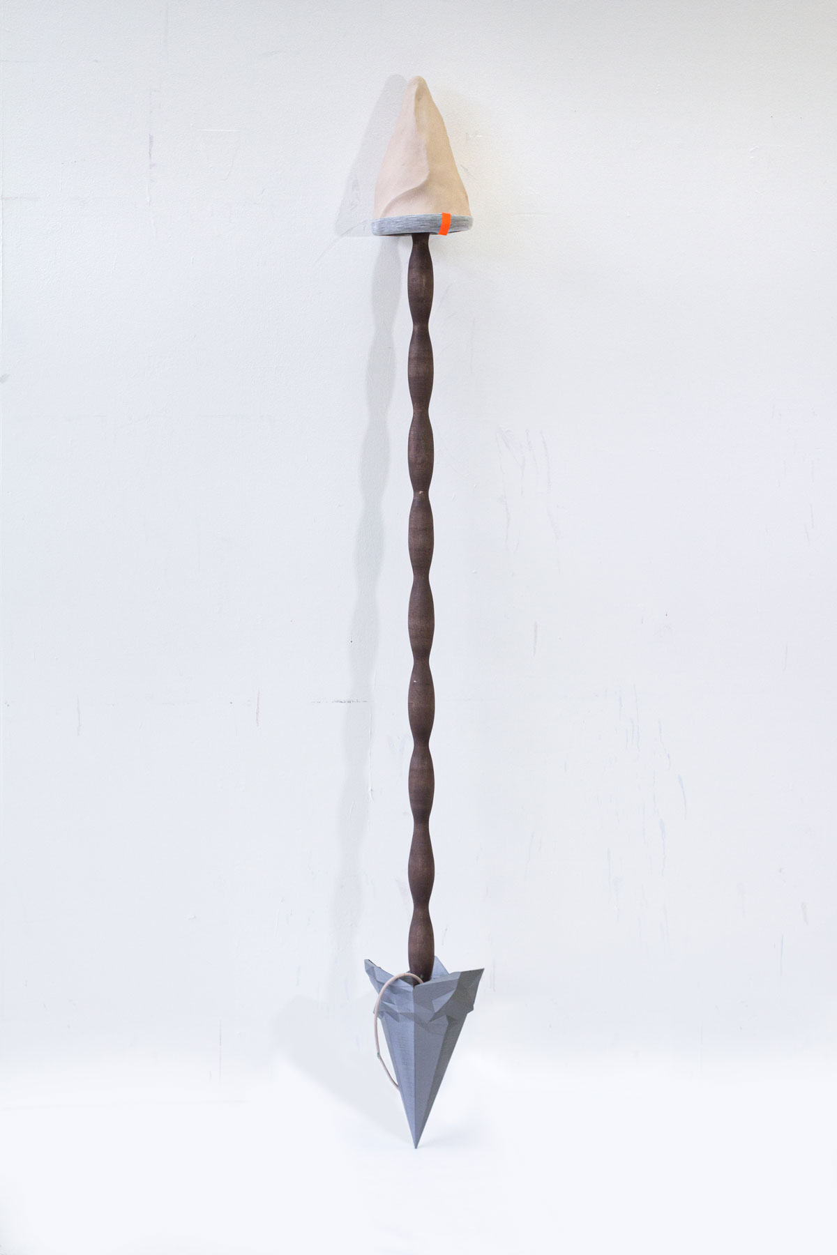 An abstract metal sculpture in the shape of an arrow.