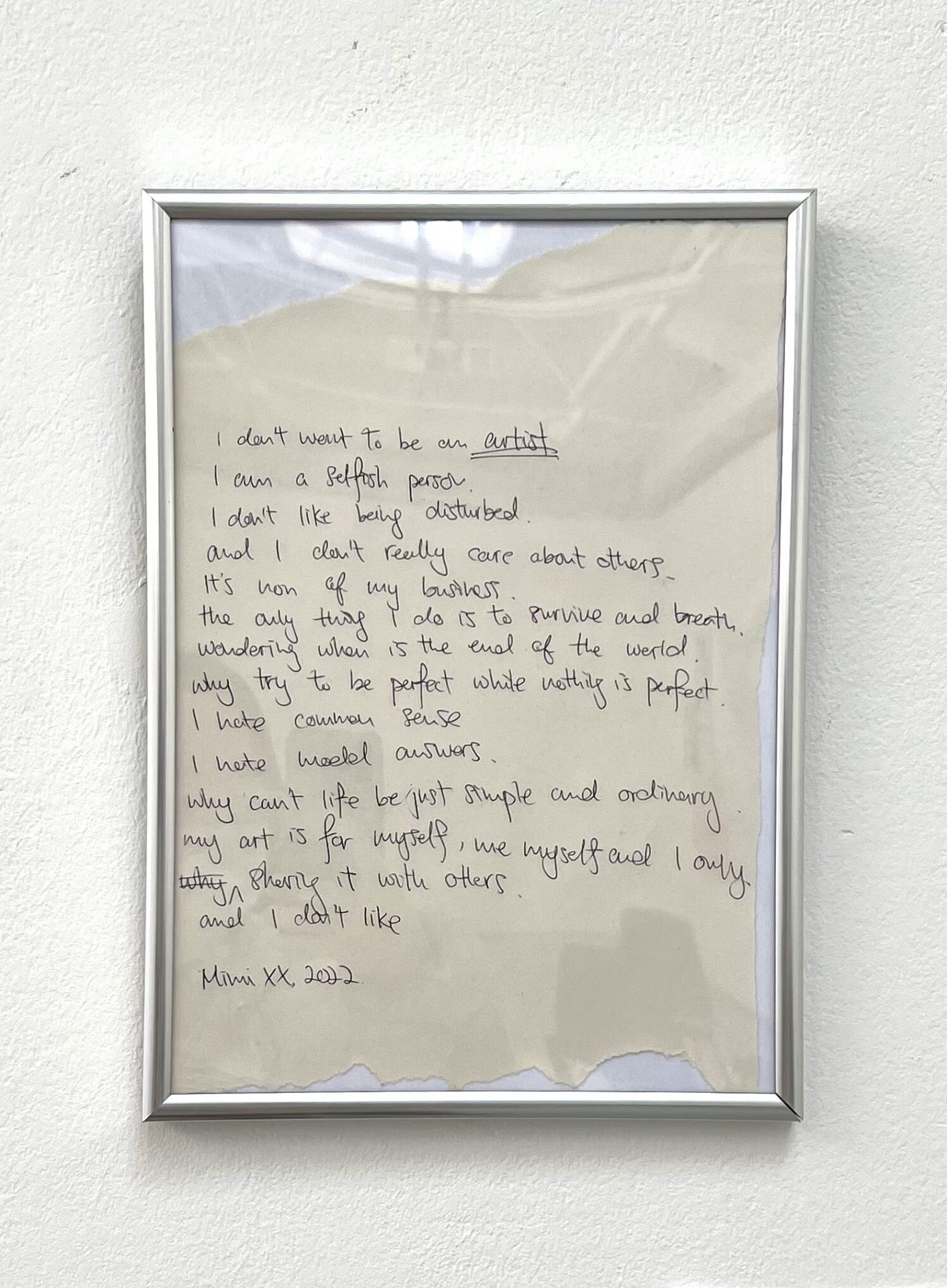 A photo of a piece of paper with writing in a silver frame.