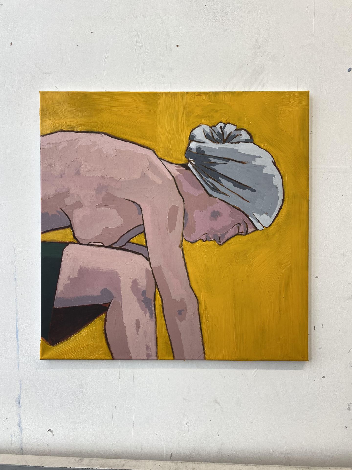 A painting of a person gazing downwards on a yellow canvas.