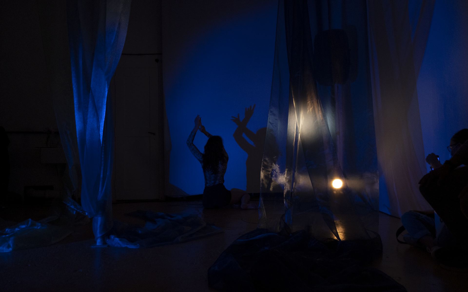 An image of a figure in a costume in a dark room.