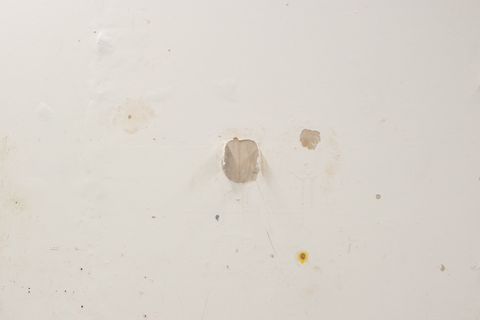 An image of some chipped paint on a white wall.