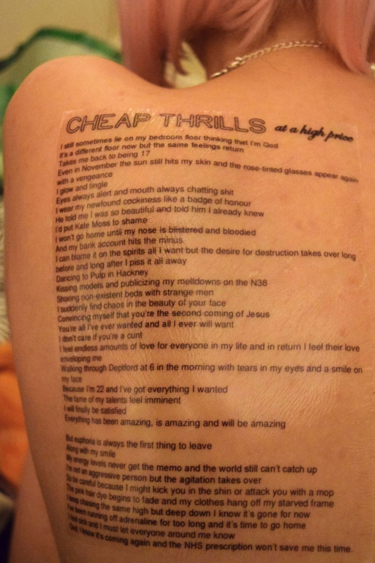 An image of a woman's back covered in black lines of text.