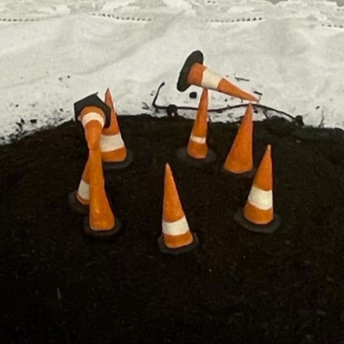 An image of several cones on a mound of dirt.