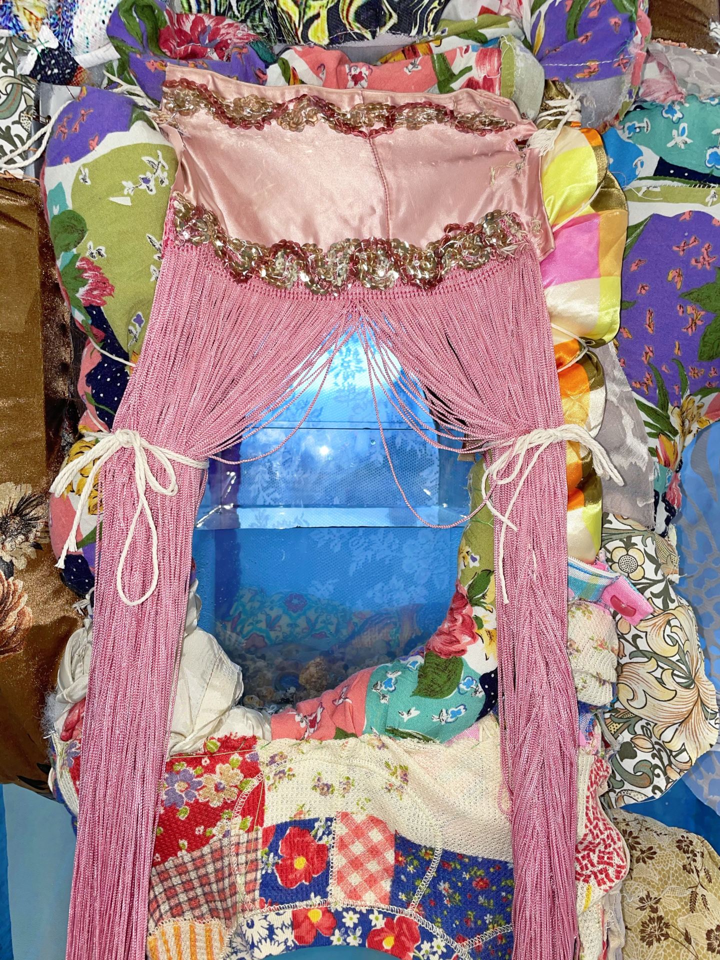 A fabric sculpture in the form of a god with a number of devices for wishing, such as wishing candles, wishing wells and shooting star launchers.