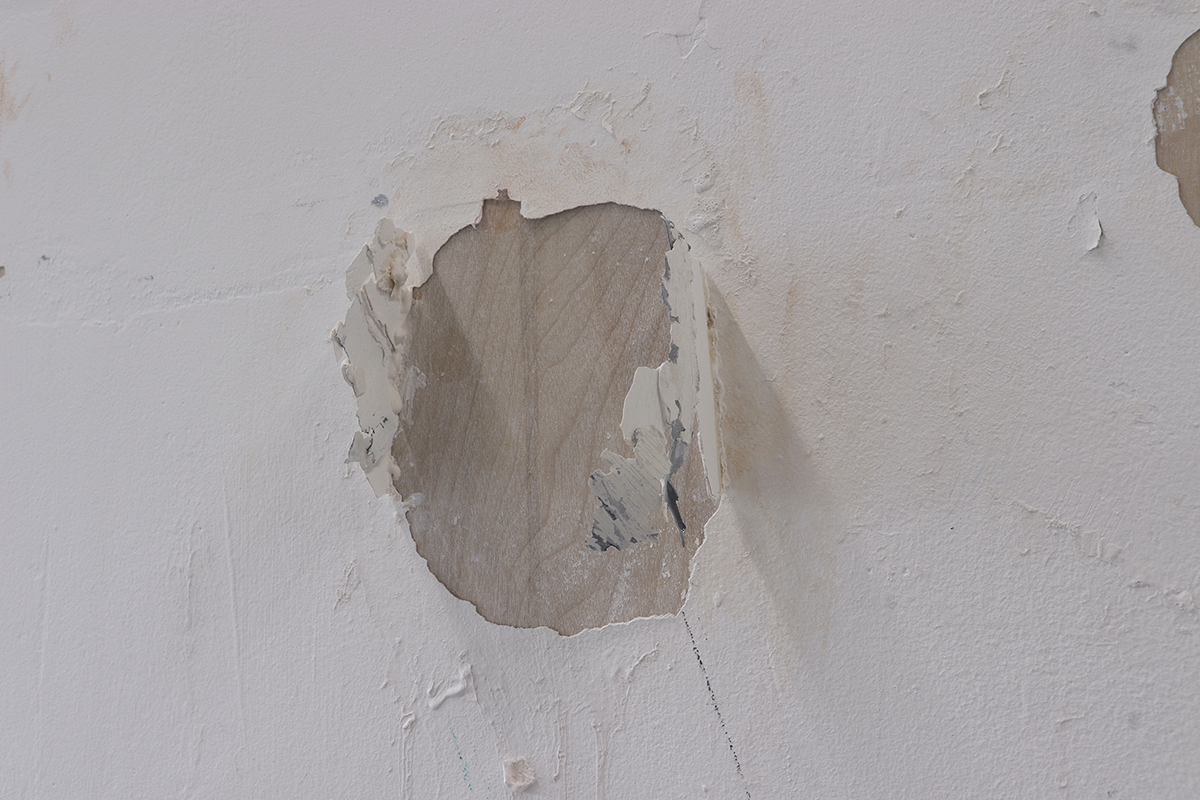 An image of some chipped paint on a white wall.