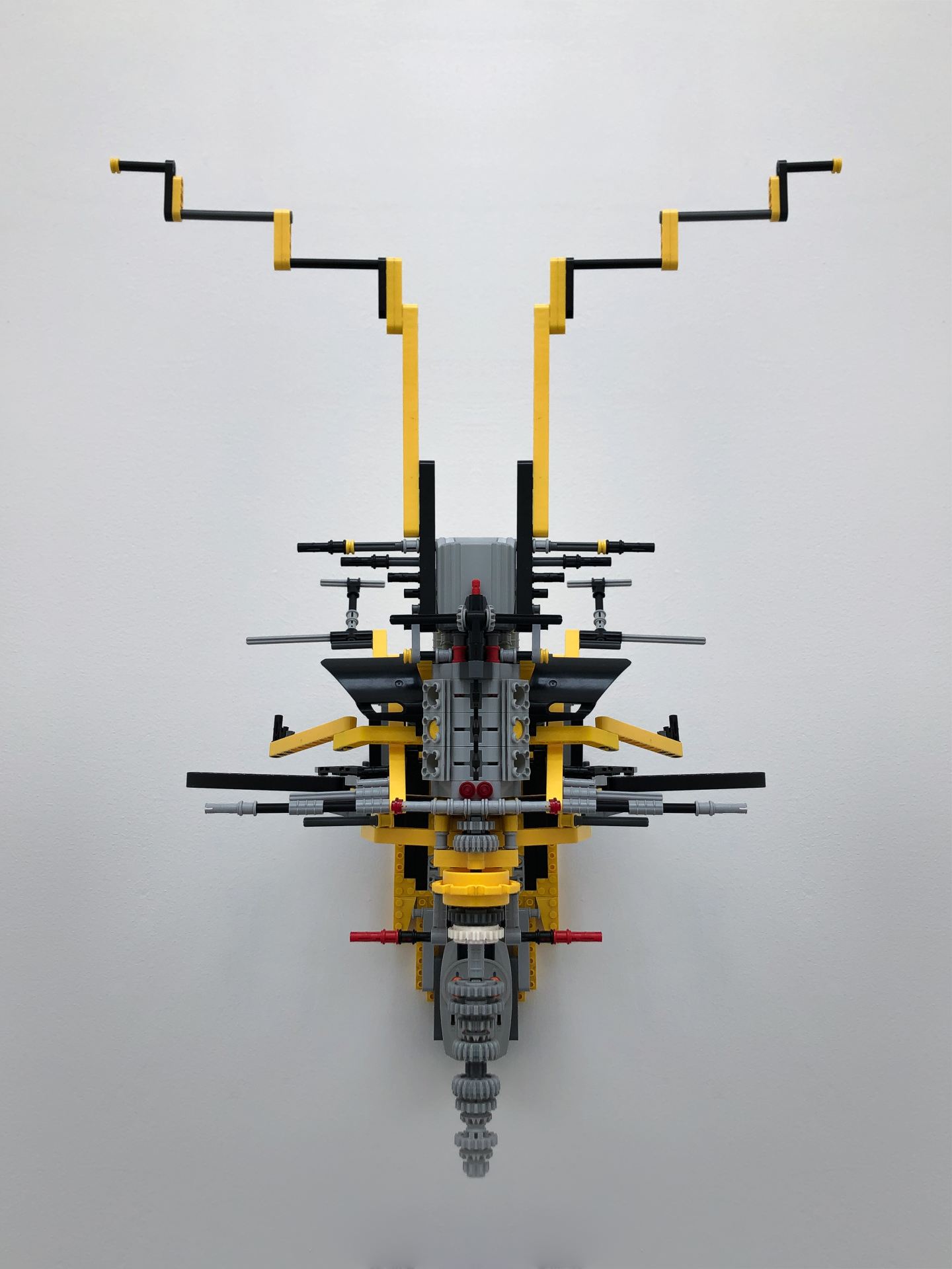 An image of a sculpture made out of Lego, against a white wall.