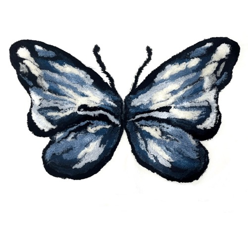 An image of a butterfly made out of blue, white and black thread against a white background.