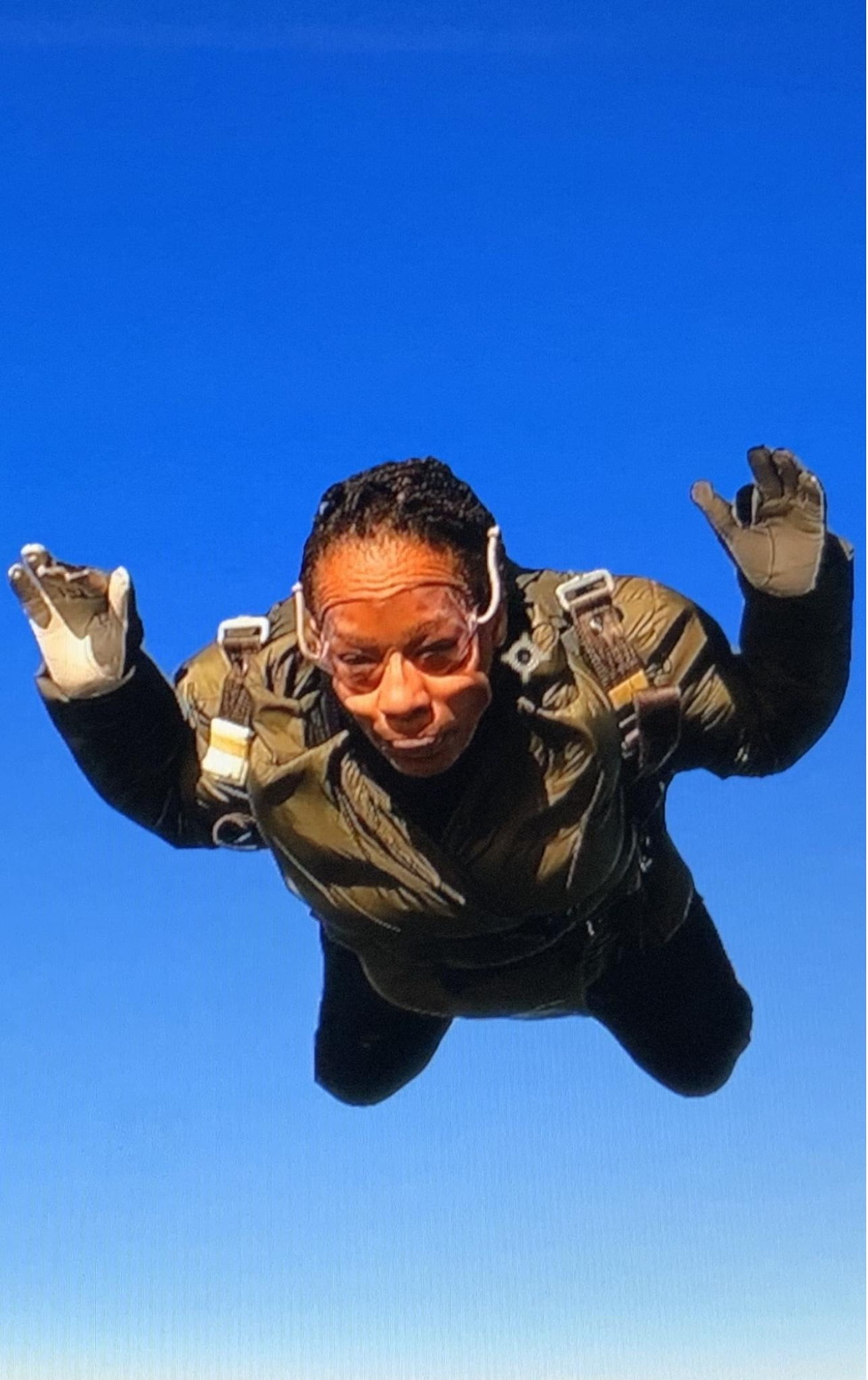 A video still of a woman skydiving.