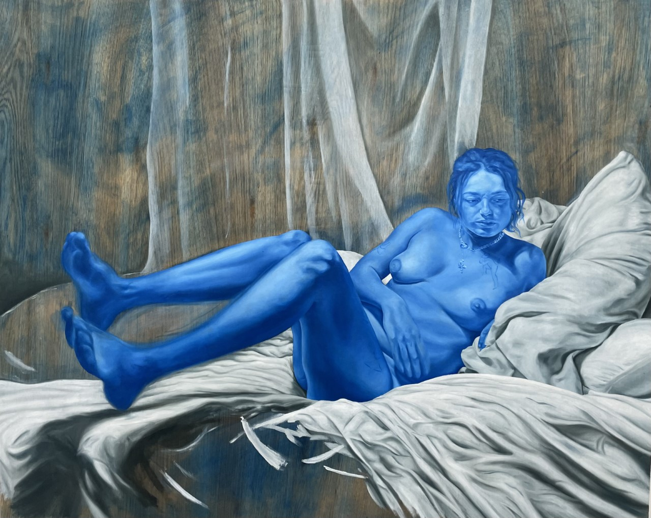 A painting of a blue woman, naked on a bed.