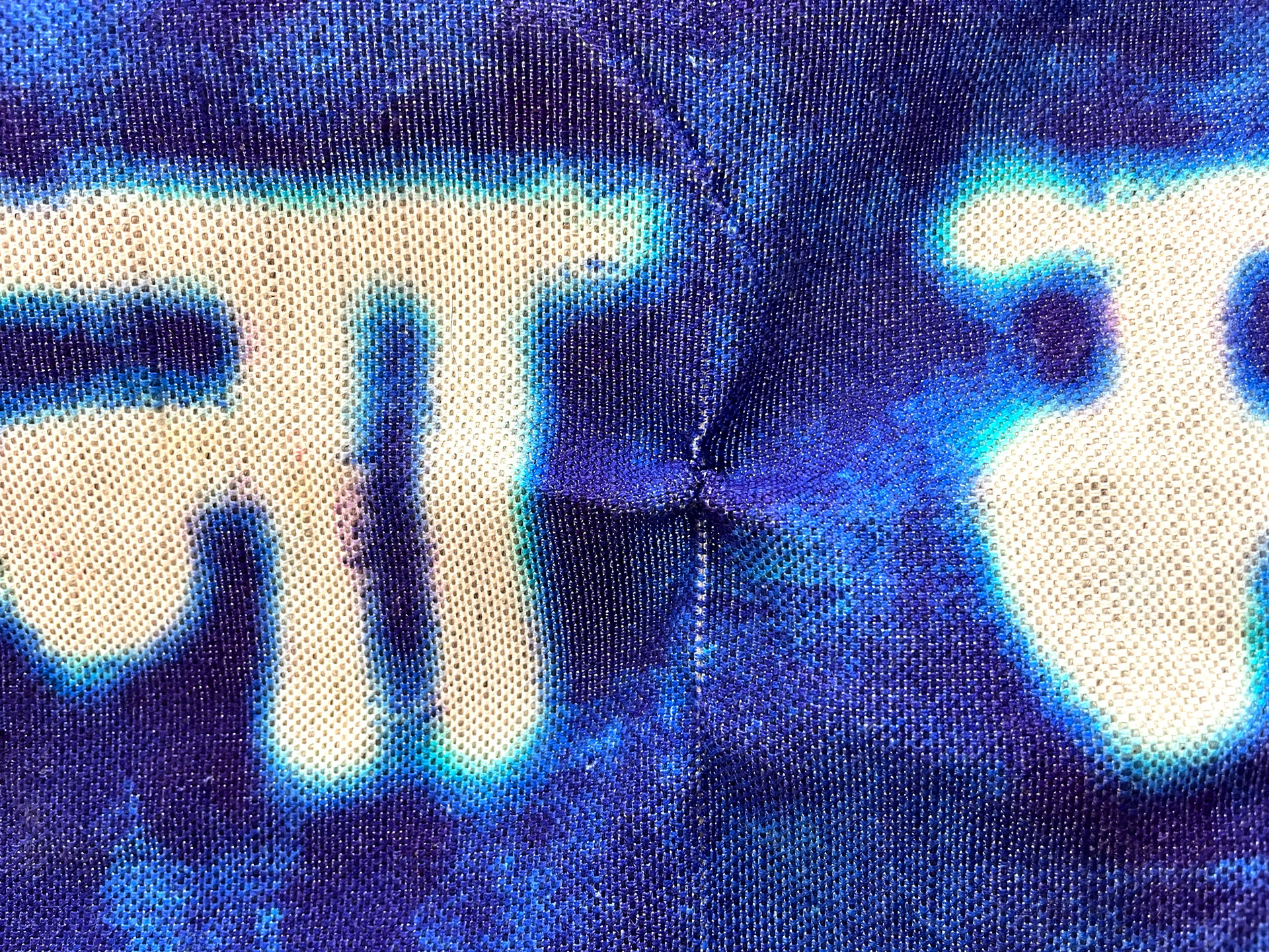 Detail of the blue and white sign on fabric.