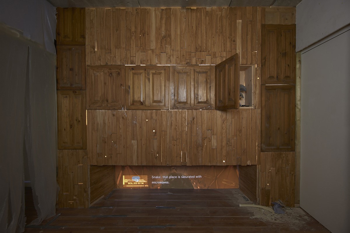 An image of a room made of wood, with an open bottom section where a video plays.