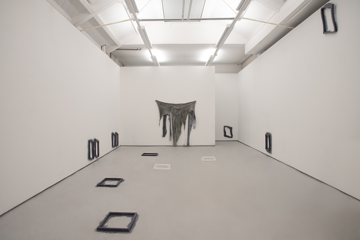 An image of an installation of several objects in a white room.
