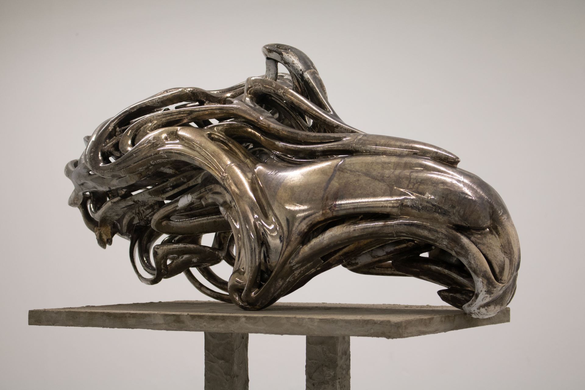 An image of a curved and abstract bronze sculpture.