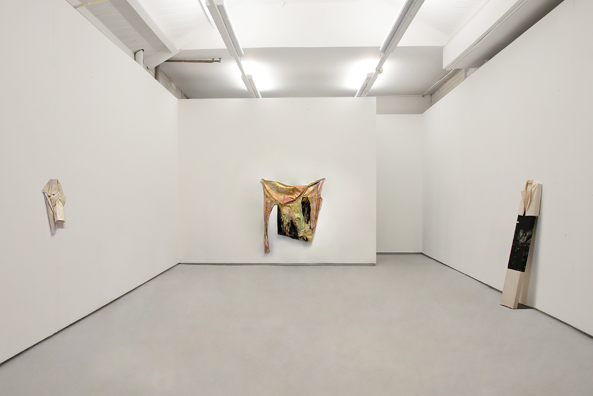 An image of an installation of several objects in a white room.