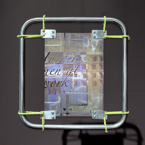 An abstracted digital is suspended in a metal square by 8 pieces of green neon rope.