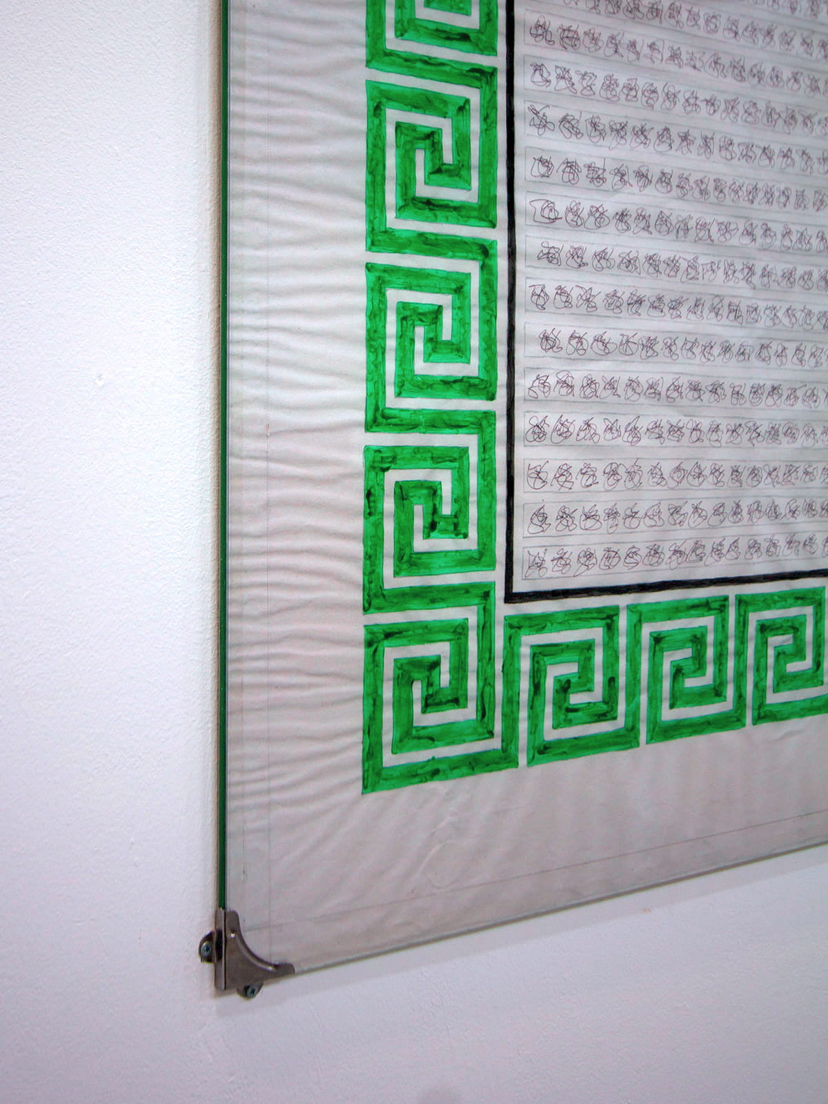 An image of a green and white poster on a white wall.