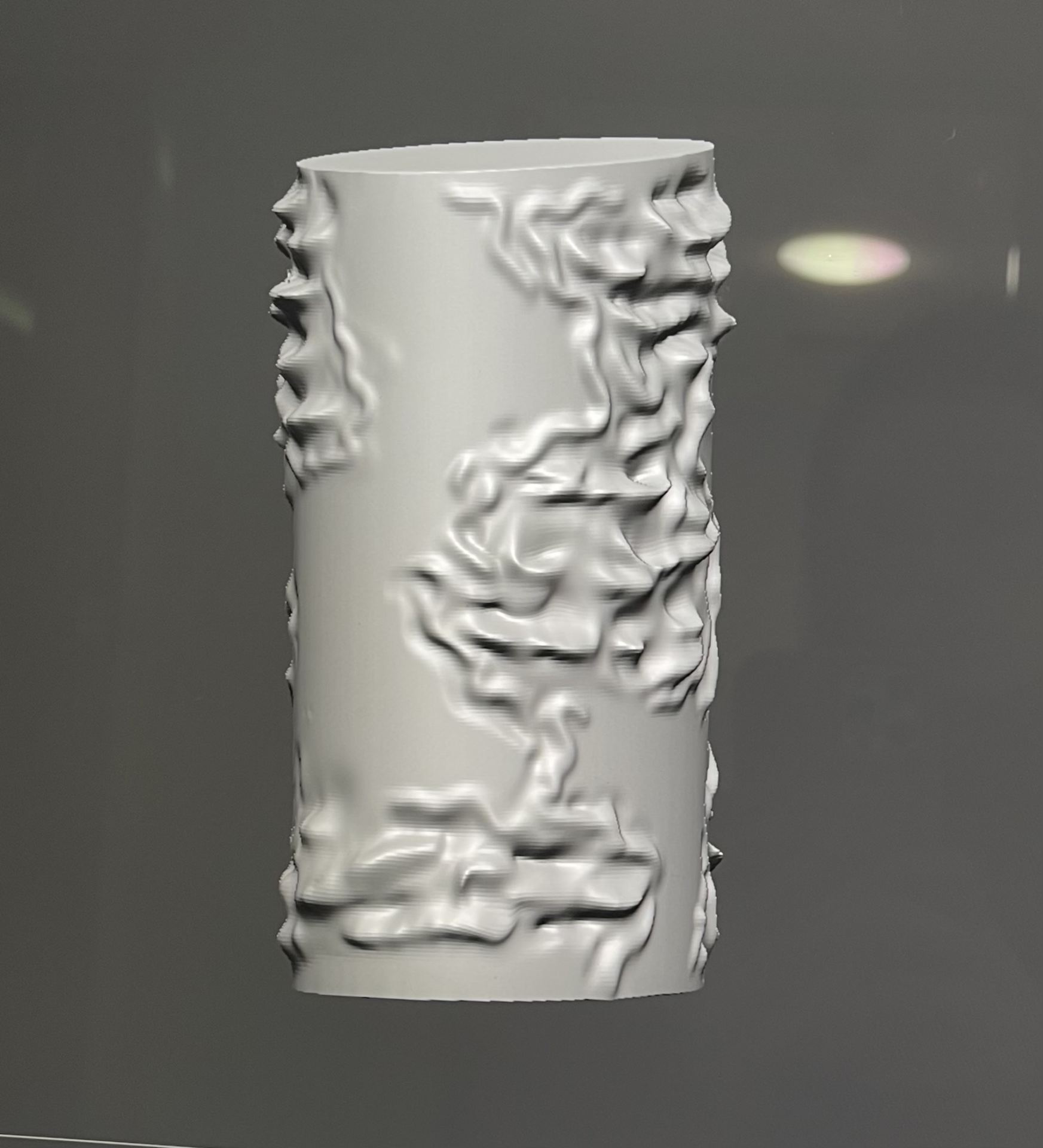 A screens hotted image of a grey object designed using the 3D sculpting software, Zbrush.
